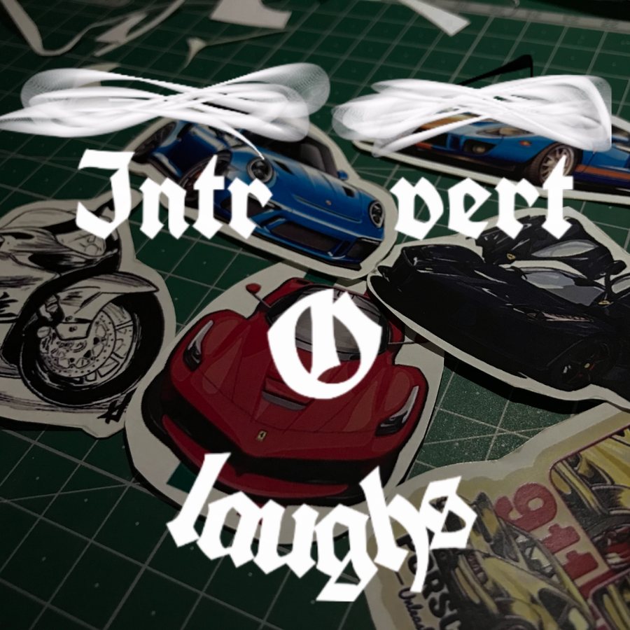 Introvert Laughs — the blackletter logo over car and motorcycle stickers on a green cutting mat