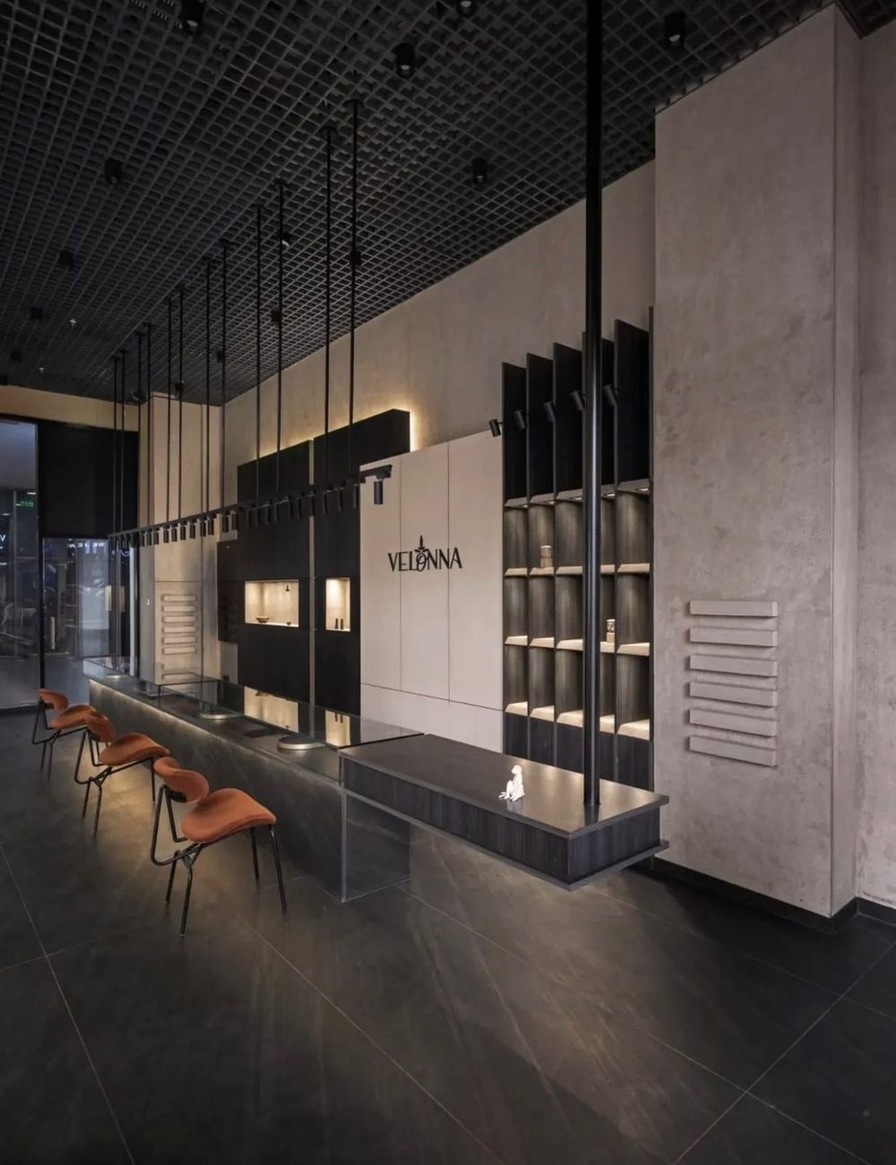 The shop floor: the shelving wall and the counter running the length of the room