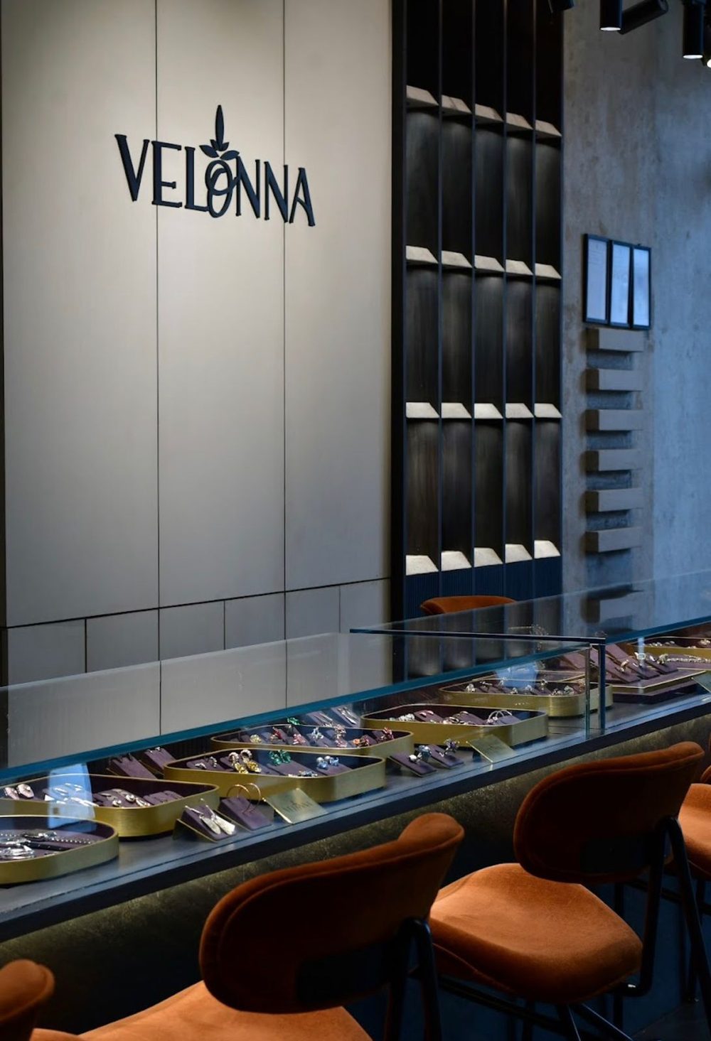 The Velonna sign on the display wall, pieces laid out along the counter