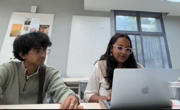Two participants at a laptop during a session